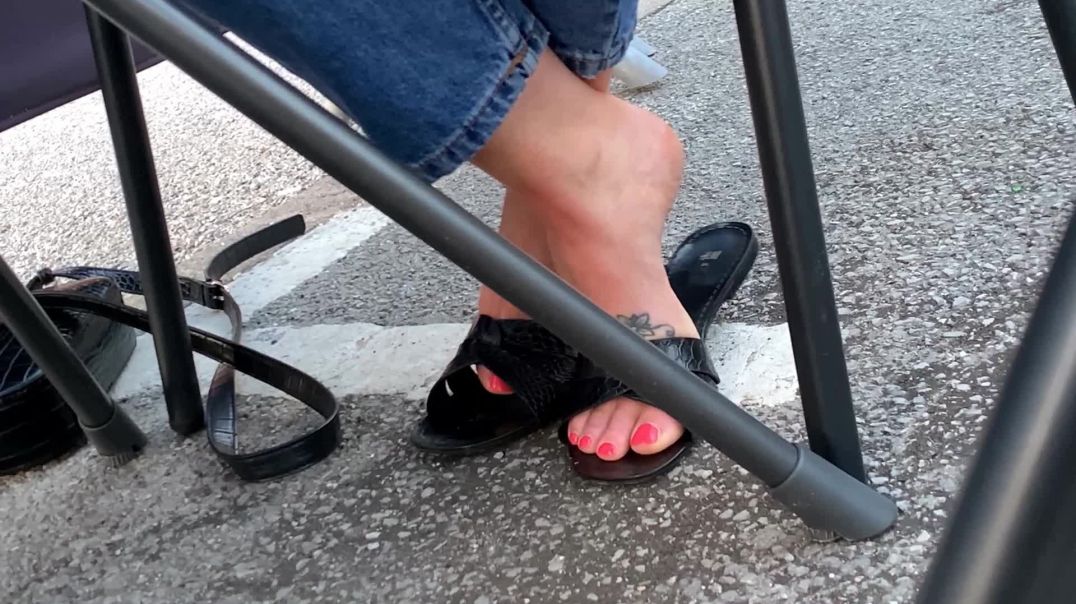 Girlfriend playing with her black sandels