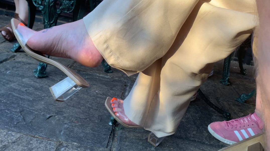 Girlfriend dangling her clear mules