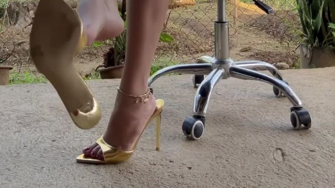 dangling high-heeled golden slides