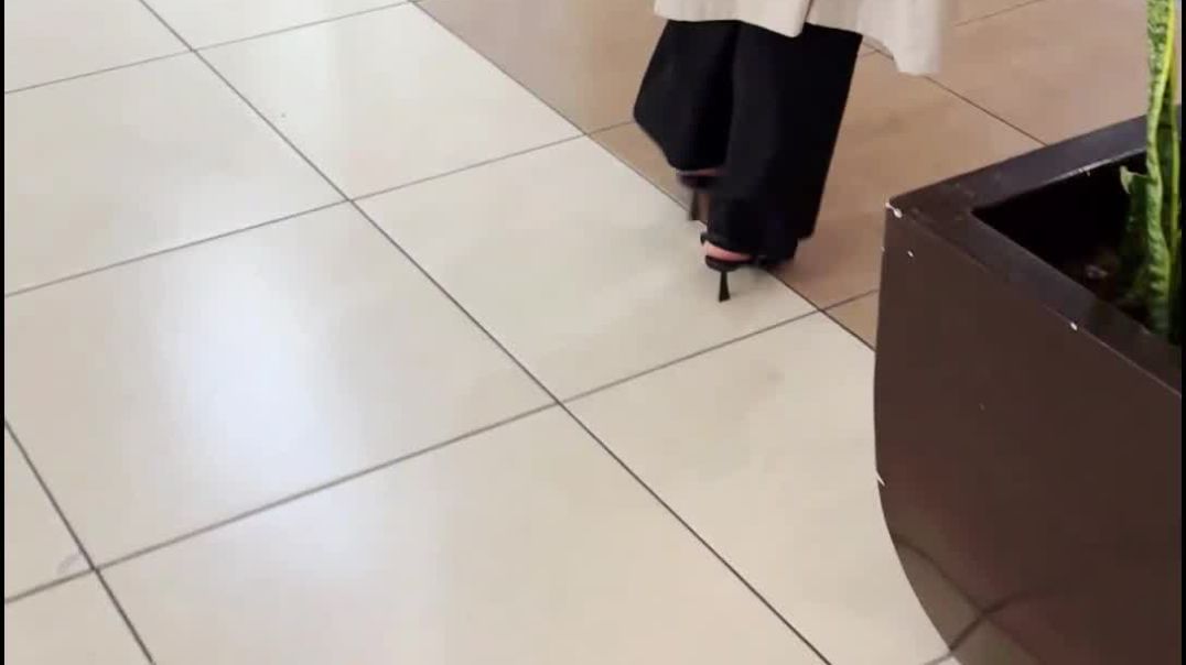 Blonde beautiful with her right heel strap sliding