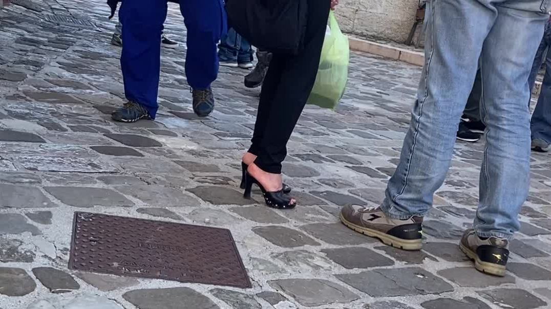 Skinny old lady in black mules