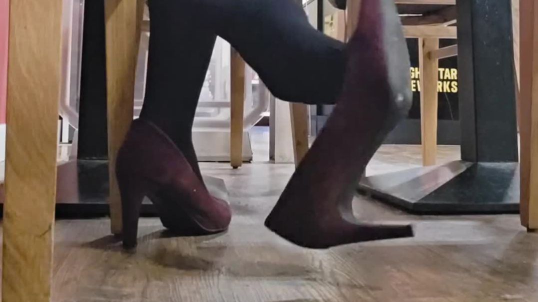candid dangling under table